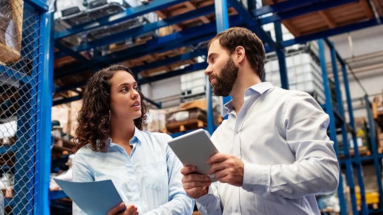 Warehouse employees checking stock levels in company warehouse. - stock photo