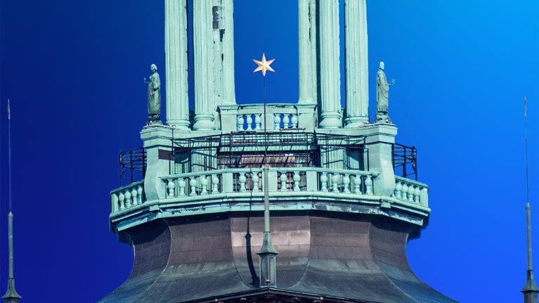 Stockholm City Hall on the eastern tip of Kungsholmen island, facing the islands of Riddarholmen and Södermalm, in Stockholm, Sweden. Its 106-metre tower is topped with the Three Crowns, the Swedish national symbol.