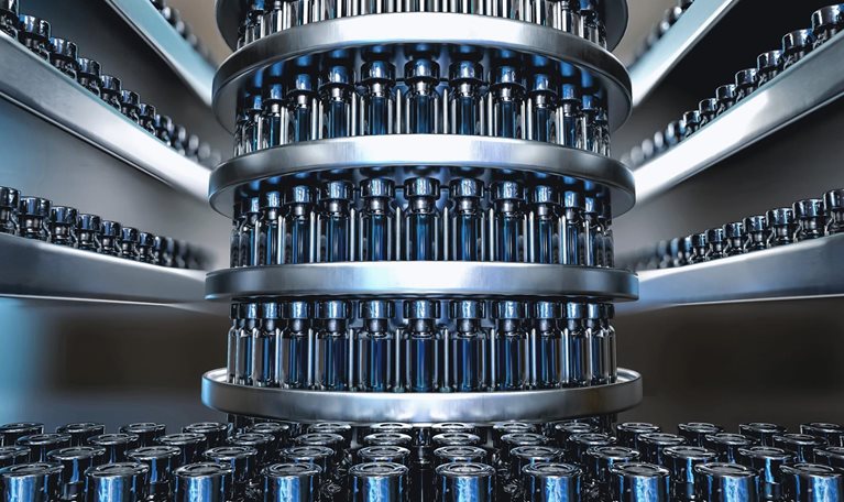 Photo of vaccine vials on an assembly line in preparation for rollout