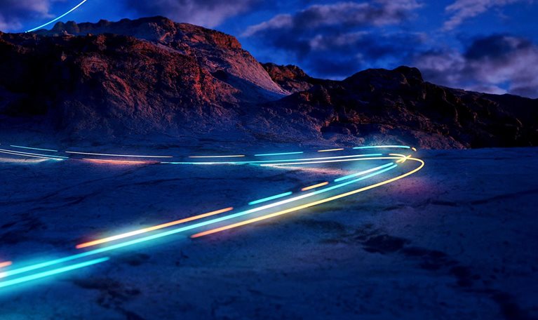 A mysterious light trail descending a mountain slope