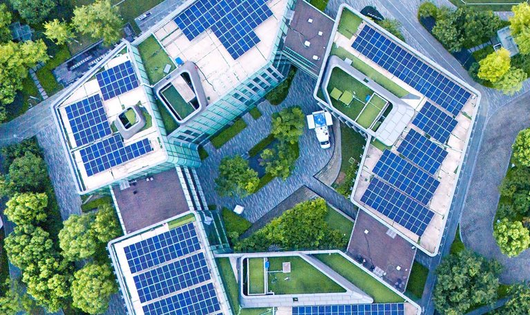 Solar panels on city rooftops at dusk