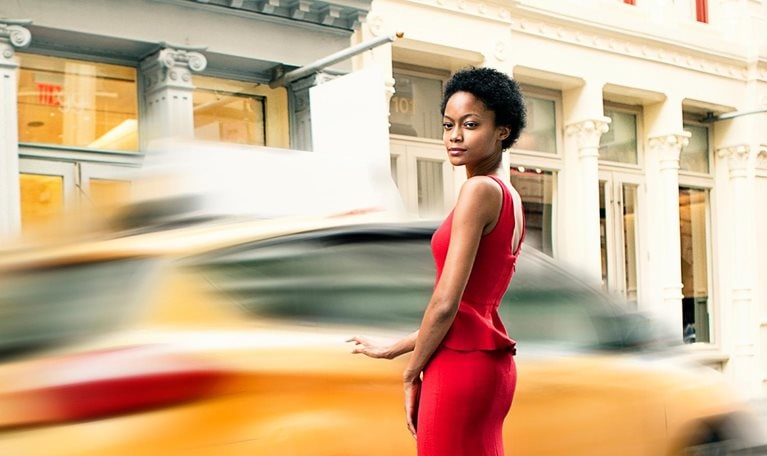 Woman wearing a red gown in Soho, New York