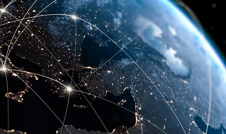 View of Earth from space with glowing lines of interconnectivity across globe.