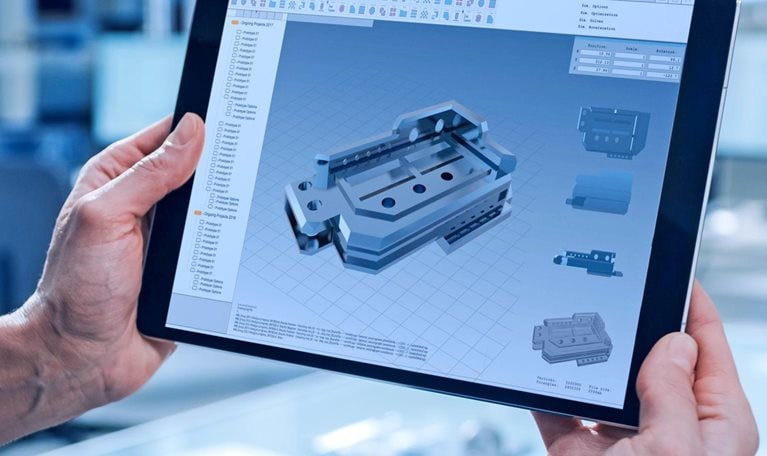 A worker using a tablet computer to operate machinery.