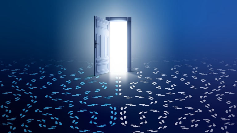 Image of a glowing, open doorway with two sets of footprints with circling paths at either side and a third set of footprints heading through the door