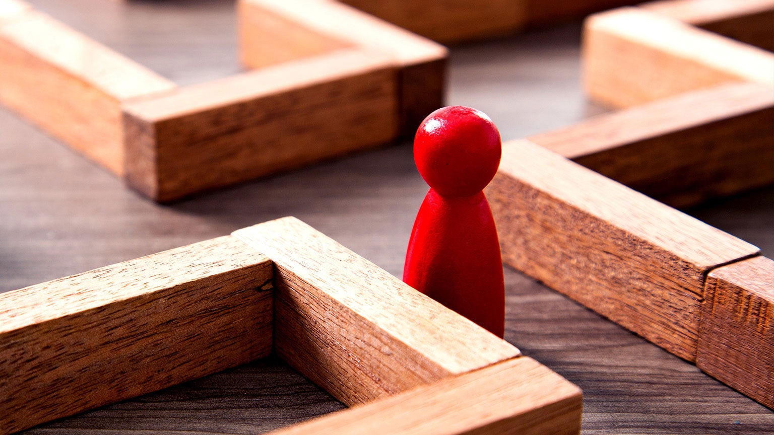 Image of a red figurine in the middle of an office cubicle layout