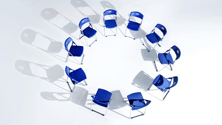 Image of 10 blue folding chairs arranged in a circle