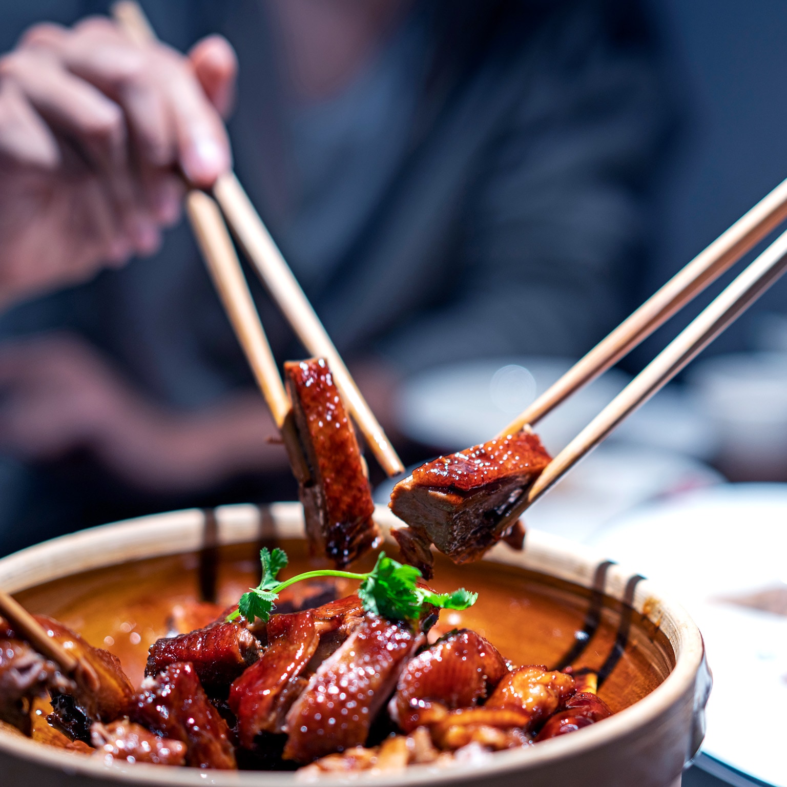 Image of chopsticks being used to pick up meat