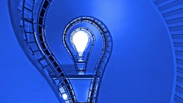 Image of a light bulb seen through blue spirals