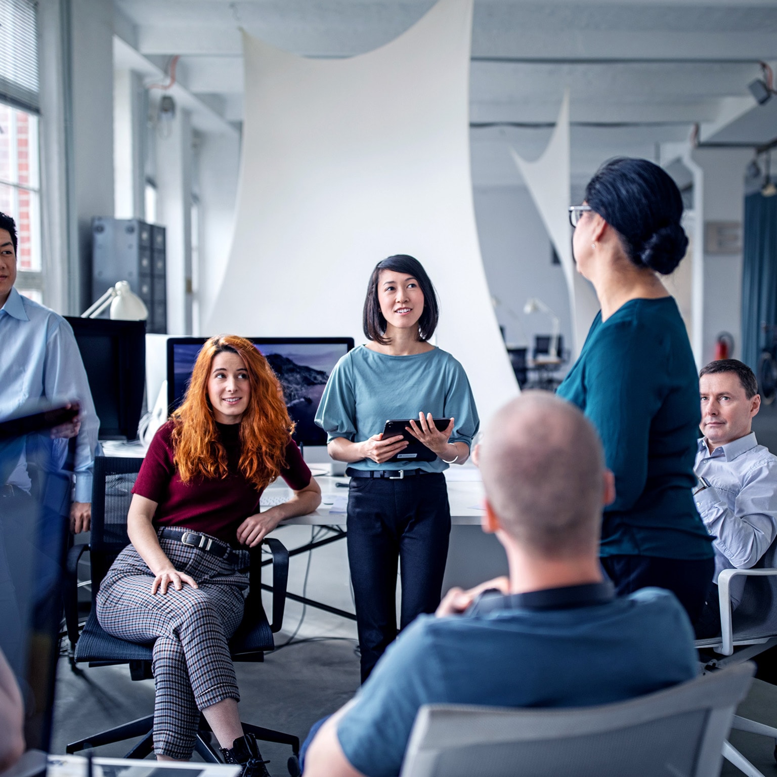 Image of employees in an effective resource group of people in an informal meeting in an office set-up