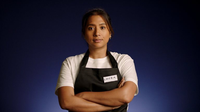 Image of a frontline worker of color in an apron