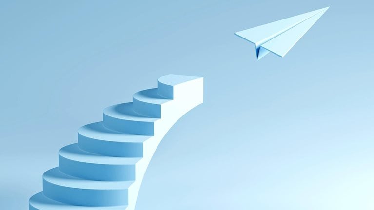A minimalist staircase rising into the sky with a paper plane taking flight