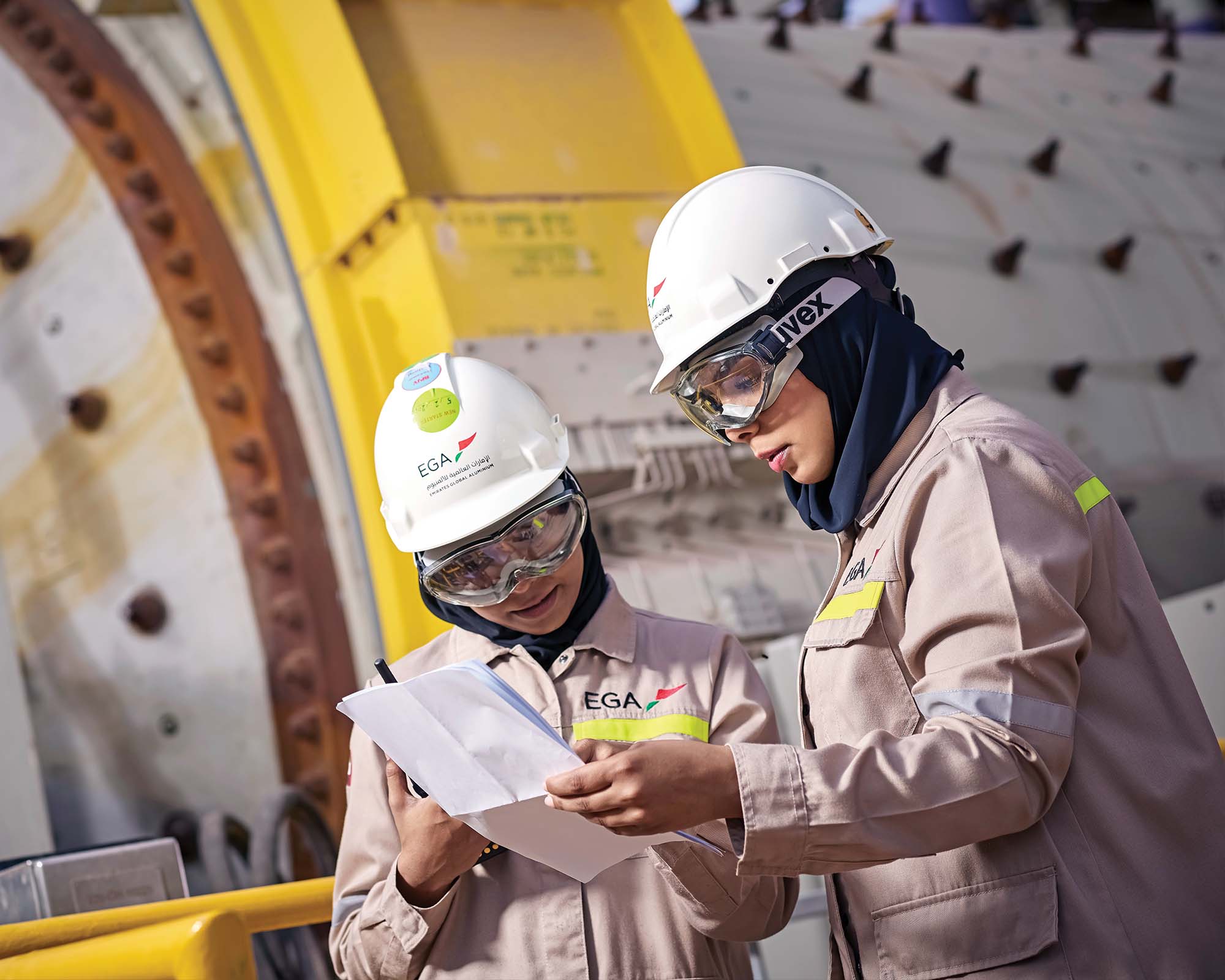 Two engineers reviewing their notes