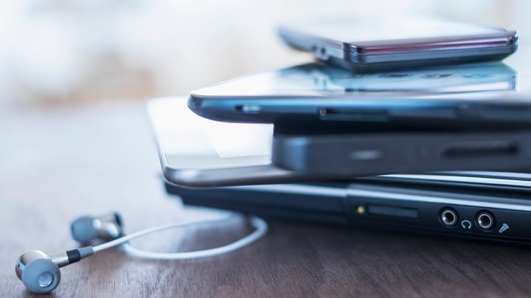 USA, New Jersey, Jersey City, Close up of stack of devices on desk - stock photo