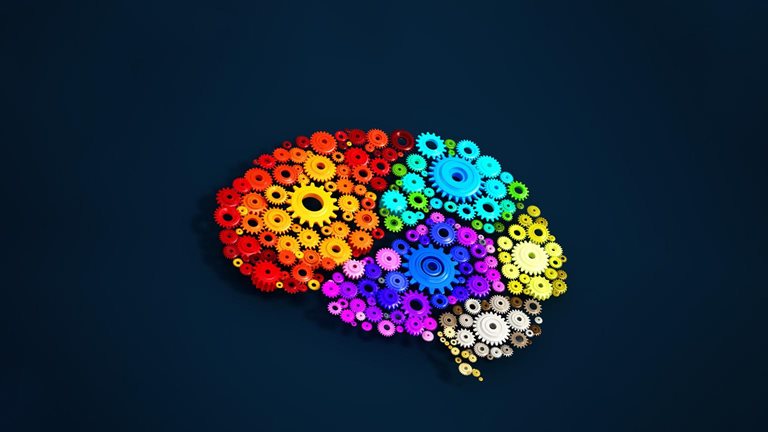 Colorful gears forming the shape of a brain on a dark blue background.