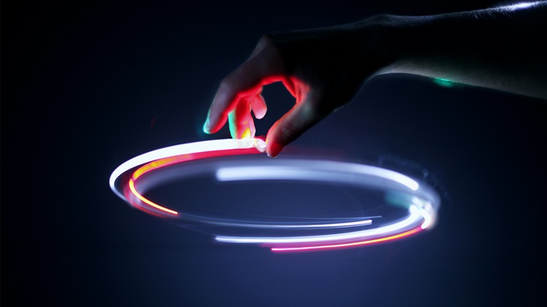 Image of a hand tracing a light circle in the air