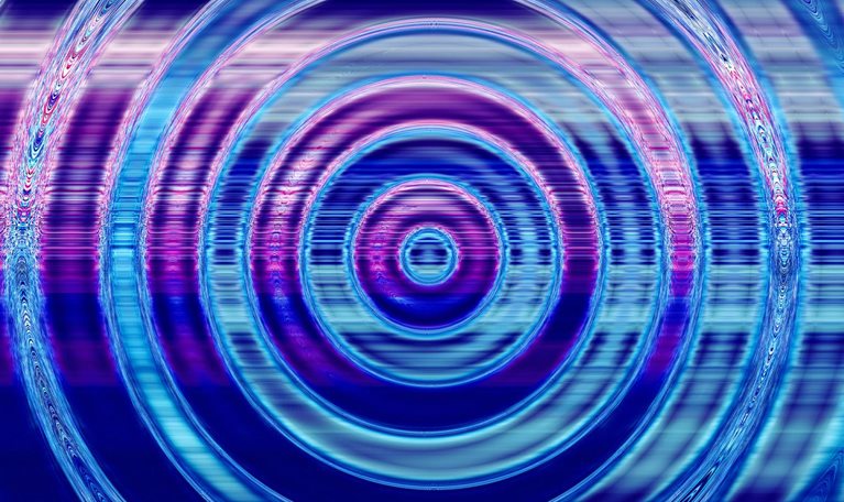 The water is rippling in a circular pattern, emanating from a central point. The hues of blue and purple dominate the image, with slight digital distortions added to the expanding ripples.