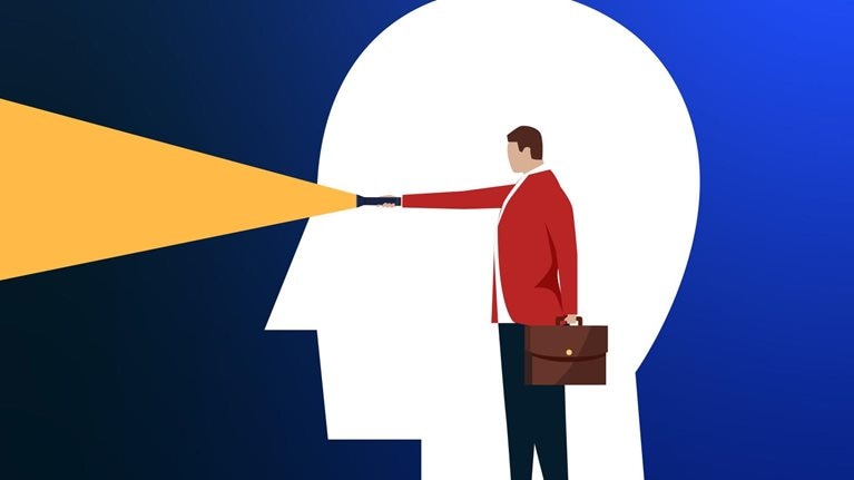 A conceptual illustration of a flat white head framing a person holding a flashlight with the beam shining out of where the eyes of the white head would be.