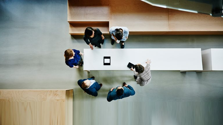 Overhead view of businesswoman leading meeting - stock photo