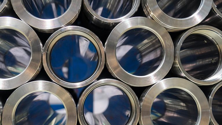 Rolls of metal pipe fittings during machining