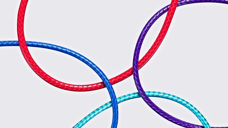 Four different color ropes crossed and converged together