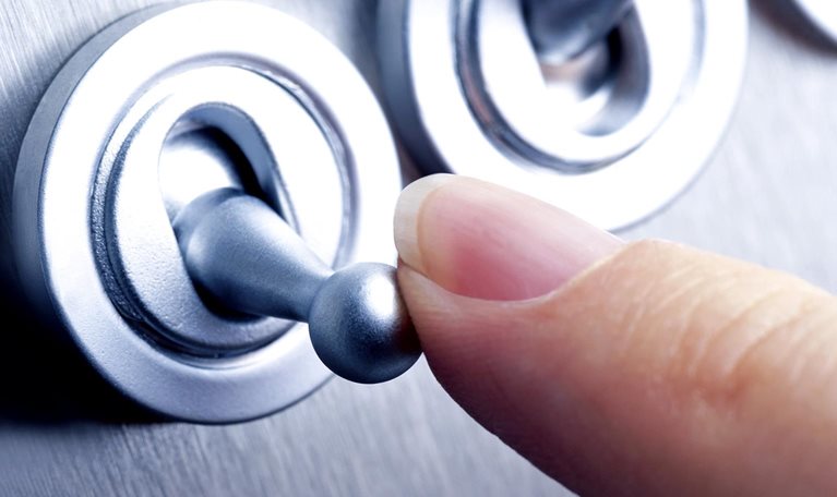 Close-up image of a person flicking a switch.