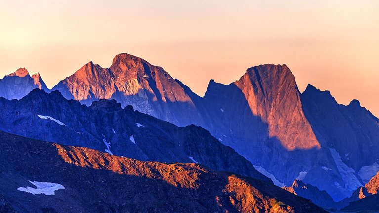 An image of a majestic mountain ridge-line at first light.
