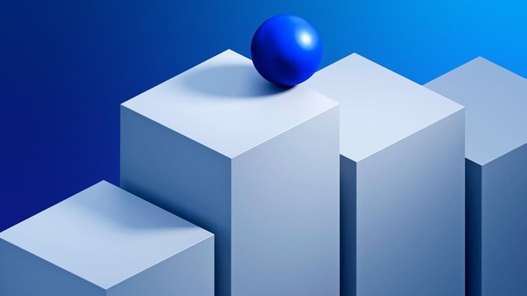 An image of a sphere balanced on top of a stack of rising blocks.