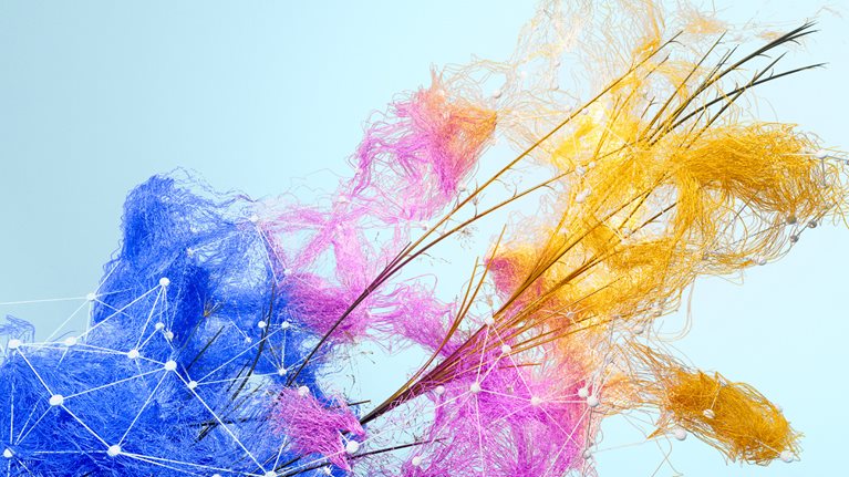 A network of vibrant threads, transitioning from blue to pink to golden yellow, sprouts over a lattice of crisscrossing branches and small white beads, all against a soft blue backdrop.