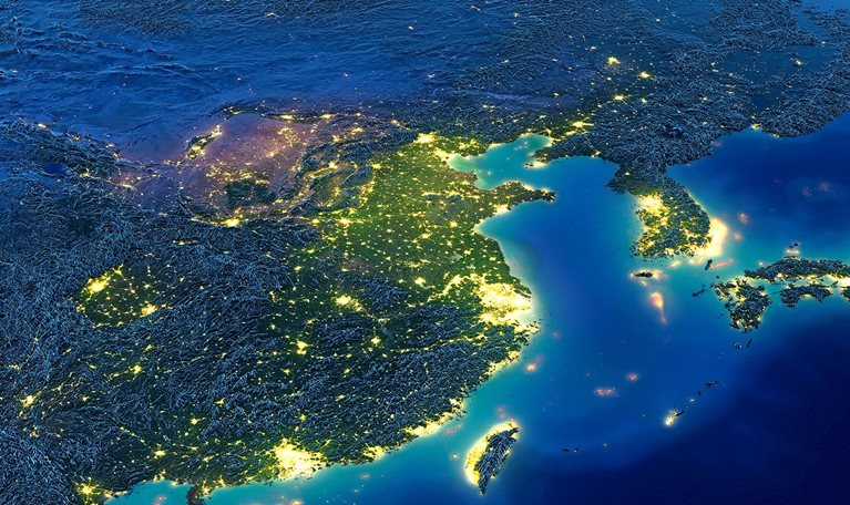 Satellite image of Earth at night with a focus of illumination on Asia