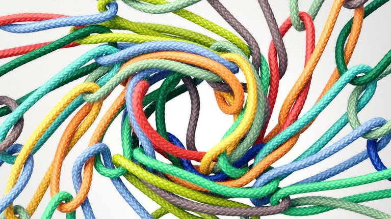 Multicolored rope rings linking together to form a vortex in the center
