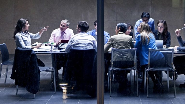 Image of a group of business professionals having a meeting in a modern office space.