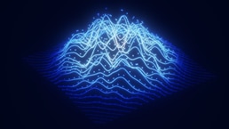 This image is a digital rendering of a futuristic wireframe landscape often used to visualize big data or sound waves. It features glowing blue lines forming hilly terrain, resembling mountains or wave patterns on a dark background. Small, scattered dots are embedded along the light trails to represent data points or particles.