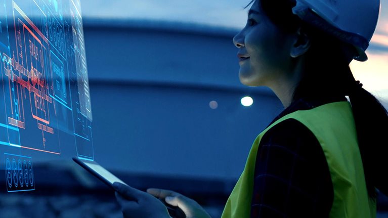 Female Engineer Using AI Digital Dashboard for Smart Factory Monitoring and Industrial Automation