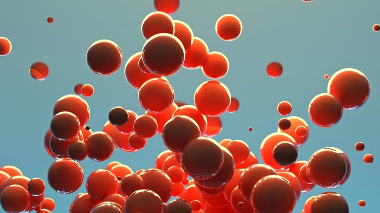 A cluster of red spheres of different sizes are released into the air