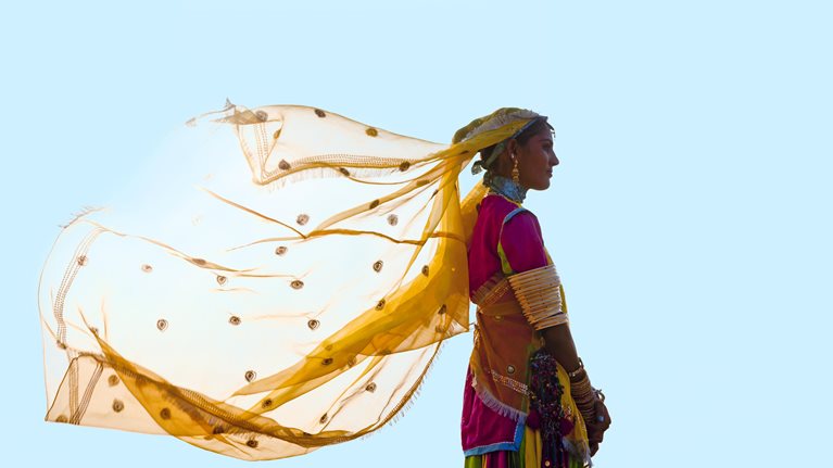 Photo of a person with clothes blowing in the wind