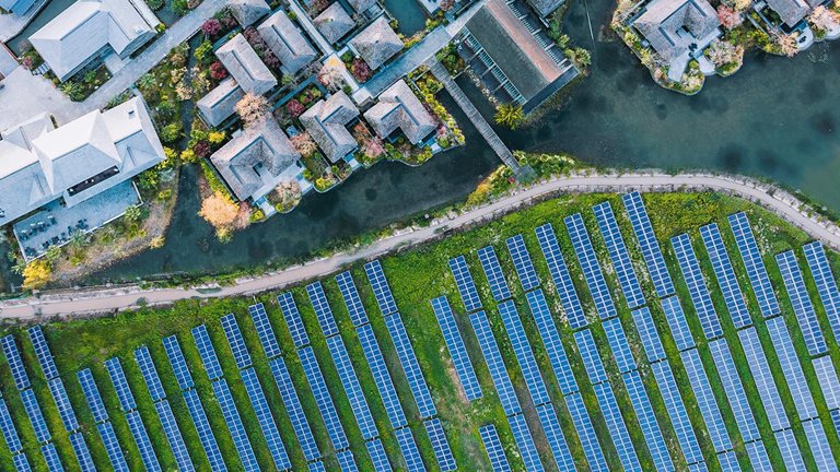 Solar power station with modern city buildings - stock photo