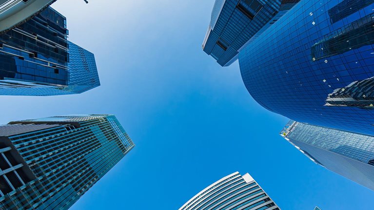 Low angle view of skyscrapers with clear blue sky
