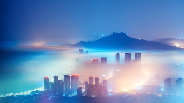 City in the mist at night - stock photo