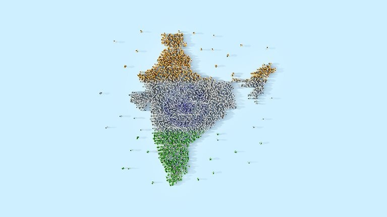 3D image of people forming the shape of India and organized based on their clothing color creating the pattern of the national flag.   