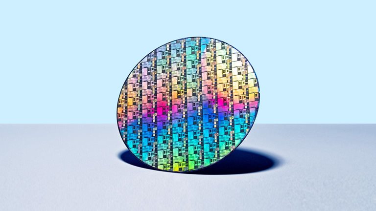 Colorful Iridescent Silicon Computer Wafer on Blue Colored Background.