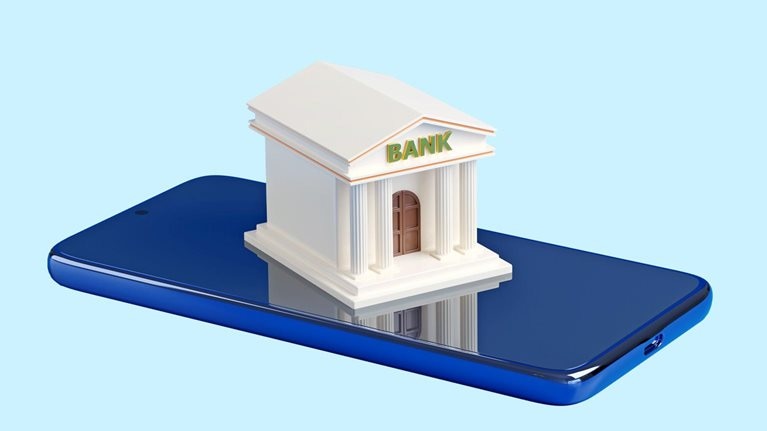 A stylized miniature bank building with the word "BANK" on its facade sits on top of a blue smartphone.