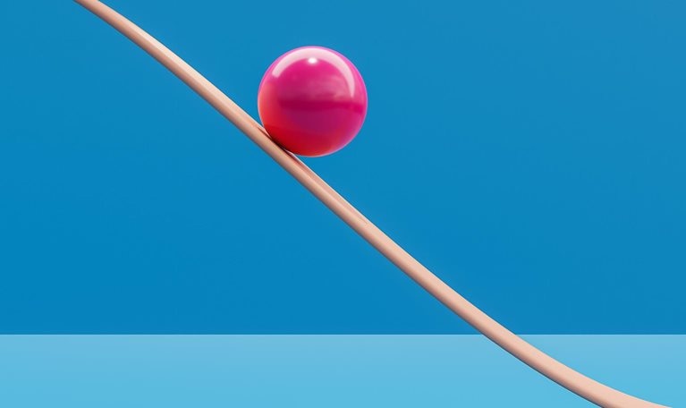 Computer generated image of pink sphere rolling down a plane like a roller coaster. - stock photo