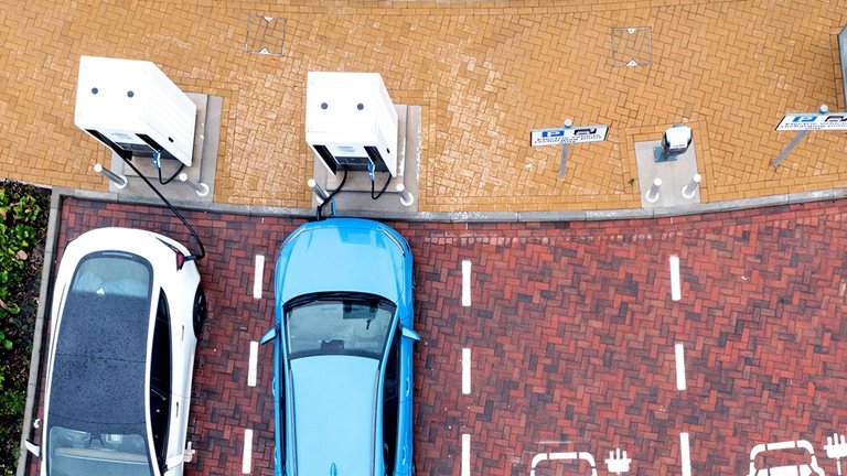 Aerial view directly above electric car being charged