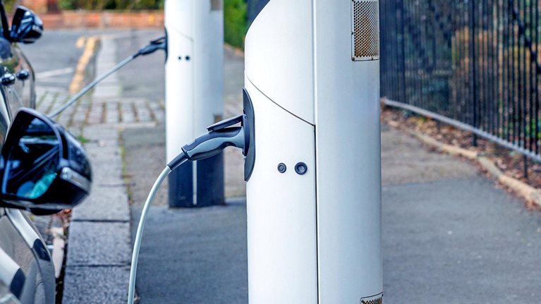 Electric cars standing in a row and charging at a public charger point