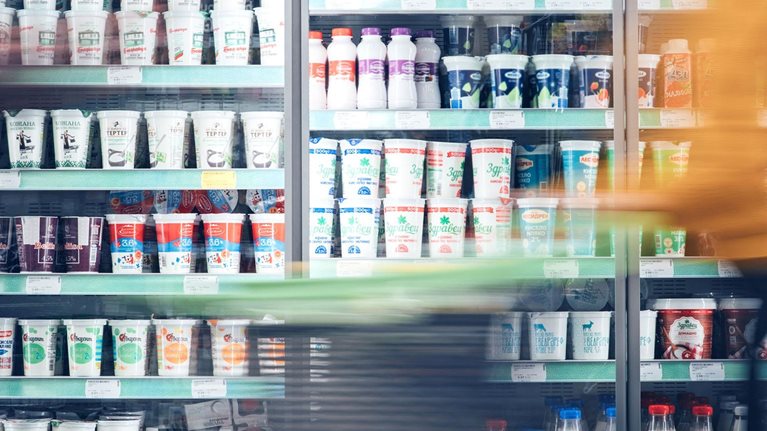 Blurred motion of energetic people on the move while shopping in a grocery store.