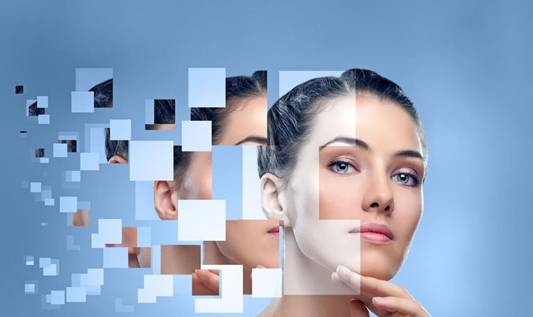 Pixelated beauty portrait of a woman on a pale blue background.