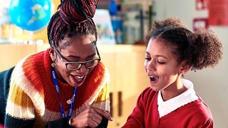 Primary school girl looking surprised as she gets the answer right