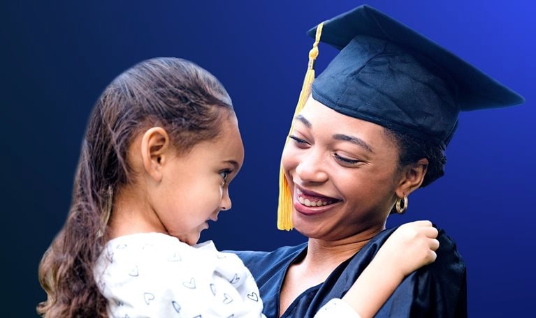 Preschool girl smiles at her mother after the graduation ceremony - stock photo