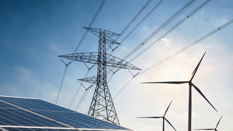 Solar panel with turbine and tower high voltage - stock photo